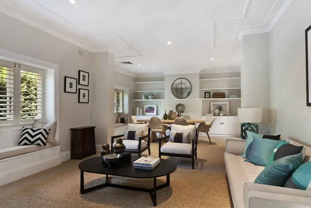 A finished family room with built-in shelving, armchairs and a coffee table
