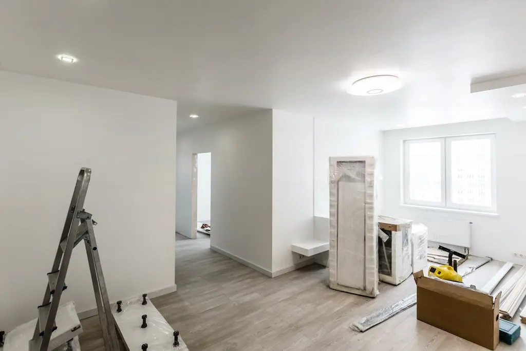 A bright white room with new walls and a ladder, ready for the finish work
