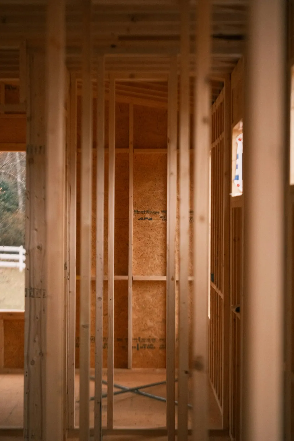 New timber wall framing with openings for a window and a door